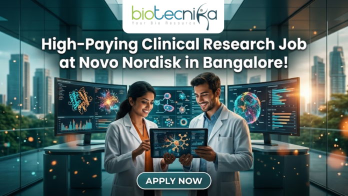 Novo Nordisk Hiring Clinical Data Scientist – High-Paying Clinical Research Job in Bangalore! Novo Nordisk Hiring Clinical Data Scientist – High-Paying Clinical Research Job in Bangalore! A promotional featured image for a job opening, featuring the headline "High-Paying Clinical Research Job at Novo Nordisk in Bangalore!" in bold white text at the top. The Biotecnika logo is positioned at the top center. The central visual shows two professional researchers—a woman and a man in white lab coats—smiling and collaborating while looking at a digital tablet that displays a glowing neural network. They are standing in a futuristic, high-tech laboratory equipped with large, curved monitors showing 3D protein structures and complex biological data. Through the large glass windows behind them, a modern city skyline is visible during a warm sunset. At the bottom center, there is a prominent, stylized "APPLY NOW" button.