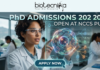 PhD Admissions 2026 Open at NCCS Pune | Life Science Graduates Must Apply Before Deadline! PhD Admissions 2026 Open at NCCS Pune Life Science Graduates Must Apply Before Deadline! A professional and futuristic featured image for PhD Admissions 2026 at NCCS Pune. The image depicts a female researcher in a white lab coat and safety goggles interacting with a vibrant, glowing 3D holographic cell model that displays complex biological pathways. The setting is a modern, high-tech laboratory with other scientists working in the background. The Biotecnika logo is placed at the top center, the main heading reads "PhD ADMISSIONS 2026 OPEN AT NCCS PUNE," and a sleek "APPLY NOW" button with a cursor icon is located at the bottom center.