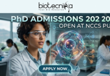 PhD Admissions 2026 Open at NCCS Pune | Life Science Graduates Must Apply Before Deadline! PhD Admissions 2026 Open at NCCS Pune Life Science Graduates Must Apply Before Deadline! A professional and futuristic featured image for PhD Admissions 2026 at NCCS Pune. The image depicts a female researcher in a white lab coat and safety goggles interacting with a vibrant, glowing 3D holographic cell model that displays complex biological pathways. The setting is a modern, high-tech laboratory with other scientists working in the background. The Biotecnika logo is placed at the top center, the main heading reads "PhD ADMISSIONS 2026 OPEN AT NCCS PUNE," and a sleek "APPLY NOW" button with a cursor icon is located at the bottom center.
