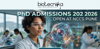 PhD Admissions 2026 Open at NCCS Pune | Life Science Graduates Must Apply Before Deadline! PhD Admissions 2026 Open at NCCS Pune Life Science Graduates Must Apply Before Deadline! A professional and futuristic featured image for PhD Admissions 2026 at NCCS Pune. The image depicts a female researcher in a white lab coat and safety goggles interacting with a vibrant, glowing 3D holographic cell model that displays complex biological pathways. The setting is a modern, high-tech laboratory with other scientists working in the background. The Biotecnika logo is placed at the top center, the main heading reads "PhD ADMISSIONS 2026 OPEN AT NCCS PUNE," and a sleek "APPLY NOW" button with a cursor icon is located at the bottom center.