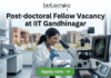 Post-doctoral Fellow Vacancy at IIT Gandhinagar. A sleek featured image for "Post-doctoral Fellow Vacancy at IIT Gandhinagar." It showcases a researcher pipetting samples in a laboratory with a university campus visible through the window. The Biotecnika logo is positioned at the top, with a green "Apply now" button at the bottom.