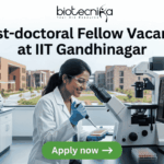 Post-doctoral Fellow Vacancy at IIT Gandhinagar | Earn Upto ₹84,000/Month Post-doctoral Fellow Vacancy at IIT Gandhinagar. A sleek featured image for "Post-doctoral Fellow Vacancy at IIT Gandhinagar." It showcases a researcher pipetting samples in a laboratory with a university campus visible through the window. The Biotecnika logo is positioned at the top, with a green "Apply now" button at the bottom.