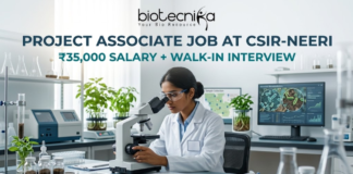 Project Associate Job at CSIR-NEERI | ₹35,000 Salary + Walk-in Interview | Don’t Miss! Project Associate Job at CSIR-NEERI ₹35,000 Salary + Walk-in Interview – Life Science Graduates Don’t Miss! A high-quality featured image for a "Project Associate Job at CSIR-NEERI." The image depicts a female scientist in a white lab coat and safety glasses, meticulously focused as she uses a microscope in a bright, modern environmental laboratory. The lab is filled with scientific equipment, soil samples in glass jars, and healthy green plants, reflecting an environmental research theme. A computer monitor in the background displays biological data and microscopic views of microbes. The Biotecnika logo is at the top, followed by the bold title and a tagline stating "₹35,000 SALARY + WALK-IN INTERVIEW." A prominent teal "APPLY NOW" button is located at the bottom center.