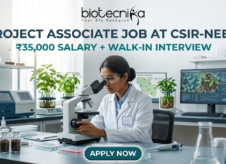 Project Associate Job at CSIR-NEERI | ₹35,000 Salary + Walk-in Interview | Don’t Miss! Project Associate Job at CSIR-NEERI ₹35,000 Salary + Walk-in Interview – Life Science Graduates Don’t Miss! A high-quality featured image for a "Project Associate Job at CSIR-NEERI." The image depicts a female scientist in a white lab coat and safety glasses, meticulously focused as she uses a microscope in a bright, modern environmental laboratory. The lab is filled with scientific equipment, soil samples in glass jars, and healthy green plants, reflecting an environmental research theme. A computer monitor in the background displays biological data and microscopic views of microbes. The Biotecnika logo is at the top, followed by the bold title and a tagline stating "₹35,000 SALARY + WALK-IN INTERVIEW." A prominent teal "APPLY NOW" button is located at the bottom center.