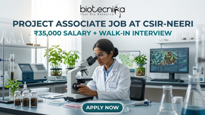 Project Associate Job at CSIR-NEERI ₹35,000 Salary + Walk-in Interview – Life Science Graduates Don’t Miss! Project Associate Job at CSIR-NEERI ₹35,000 Salary + Walk-in Interview – Life Science Graduates Don’t Miss! A high-quality featured image for a "Project Associate Job at CSIR-NEERI." The image depicts a female scientist in a white lab coat and safety glasses, meticulously focused as she uses a microscope in a bright, modern environmental laboratory. The lab is filled with scientific equipment, soil samples in glass jars, and healthy green plants, reflecting an environmental research theme. A computer monitor in the background displays biological data and microscopic views of microbes. The Biotecnika logo is at the top, followed by the bold title and a tagline stating "₹35,000 SALARY + WALK-IN INTERVIEW." A prominent teal "APPLY NOW" button is located at the bottom center.