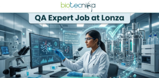 Limited Openings! QA Expert Job at Lonza Careers Hyderabad – Apply Fast! QA Job at Lonza Careers | QA Expert Hyderabad Role. A professional promotional image for a "QA Expert Job at Lonza" featuring the Biotecnika logo at the top. The scene depicts a female scientist in a white lab coat working in a state-of-the-art biotechnology facility. She is analyzing molecular data on a large computer monitor while a glowing holographic overlay displays a large green checkmark and text such as "GMP VALIDATION" and "SYSTEM PASSED." The background shows modern stainless steel bioreactors and laboratory equipment, emphasizing a high-standard Quality Assurance environment. A prominent teal "APPLY NOW" button is positioned at the bottom center.