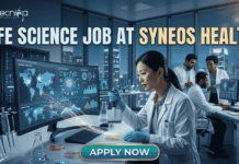 Top Life Science Job at Syneos Health – Central Monitor Role Hiring Now! Life Science Job at Syneos Health | Central Monitor Role. A professional promotional graphic for a "Life Science Job at Syneos Health" featuring the Biotecnika logo at the top. The image depicts a female scientist in a white lab coat and blue gloves using a multichannel pipette on a microplate in a modern, high-tech laboratory. A large computer monitor in the foreground displays complex global data visualizations, including a world map with interconnected nodes, cellular diagrams, and data graphs. In the background, other researchers are seen working at their stations. The laboratory features large glass windows that reveal a glowing city skyline at night. A large, prominent "APPLY NOW" button is centered at the bottom.