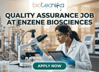 Latest Quality Assurance Job at Enzene Biosciences | Biotechnology & Microbiology Candidates Apply Now A professional promotional graphic for a Quality Assurance Job at Enzene Biosciences. At the top center is the Biotecnika Professional logo, followed by the headline "QUALITY ASSURANCE JOB AT ENZENE BIOSCIENCES" in bold, dark green lettering. The image features a female scientist in a white lab coat and safety glasses, focused on a digital tablet while working in a high-tech laboratory. The setting includes a microscope, rows of clear vials on a lab bench, and large-scale industrial bioreactors in the background. A glowing teal "APPLY NOW" button is positioned prominently at the bottom center.