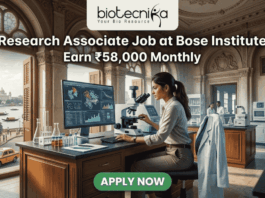 Research Associate Job at Bose Institute – Earn ₹58,000 Monthly in Top Life Science Project! A professional featured image for a job posting titled "Research Associate Job at Bose Institute" with a tagline "Earn ₹58,000 Monthly." The image depicts a female scientist in a white lab coat and glasses working with a microscope and a computer monitor displaying complex molecular structures. The setting is a majestic, classical laboratory with high arched windows and ornate architecture. Visible through the window is a scenic view of Kolkata, featuring a signature yellow taxi and a river with traditional boats. The Biotecnika logo is positioned at the top, and a prominent green "APPLY NOW" button is located at the bottom center.