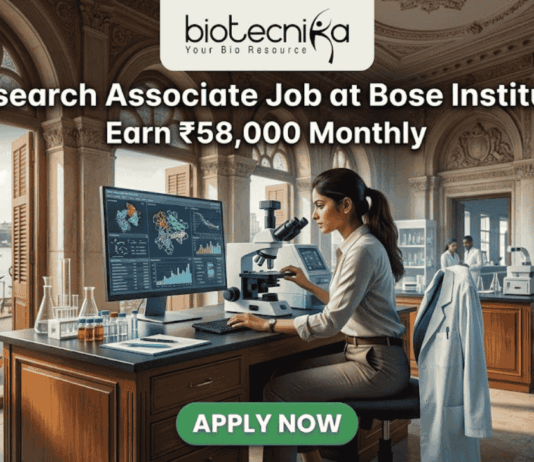 Research Associate Job at Bose Institute – Earn ₹58,000 Monthly in Top Life Science Project! A professional featured image for a job posting titled "Research Associate Job at Bose Institute" with a tagline "Earn ₹58,000 Monthly." The image depicts a female scientist in a white lab coat and glasses working with a microscope and a computer monitor displaying complex molecular structures. The setting is a majestic, classical laboratory with high arched windows and ornate architecture. Visible through the window is a scenic view of Kolkata, featuring a signature yellow taxi and a river with traditional boats. The Biotecnika logo is positioned at the top, and a prominent green "APPLY NOW" button is located at the bottom center.