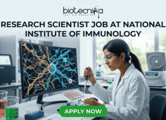 Research Scientist Job at National Institute of Immunology | Cancer Biology Project Hiring Now! Research Scientist Job at National Institute of Immunology – Cancer Biology Project Hiring Now! "A featured image job banner titled 'RESEARCH SCIENTIST JOB AT NATIONAL INSTITUTE OF IMMUNOLOGY' and featuring the biotecnika 'IMMUNOLOG TECH' logo, depicting a focused Indian female scientist in a lab coat using a pipette while a complex, multi-colored 3D map of immune cell pathways is displayed on her curved monitor, with other high-tech lab equipment in the blurred background and a green 'APPLY NOW' button at the bottom."