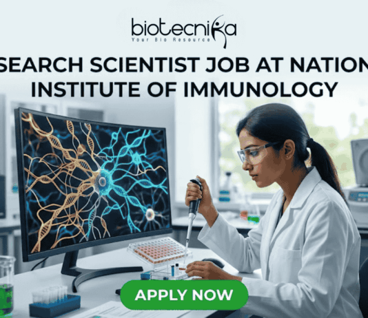 Research Scientist Job at National Institute of Immunology – Cancer Biology Project Hiring Now! "A featured image job banner titled 'RESEARCH SCIENTIST JOB AT NATIONAL INSTITUTE OF IMMUNOLOGY' and featuring the biotecnika 'IMMUNOLOG TECH' logo, depicting a focused Indian female scientist in a lab coat using a pipette while a complex, multi-colored 3D map of immune cell pathways is displayed on her curved monitor, with other high-tech lab equipment in the blurred background and a green 'APPLY NOW' button at the bottom."