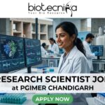 Research Scientist Job at PGIMER Chandigarh PhD in Life Sciences Candidates Apply Now. A 1280x720 image for a "Research Scientist Job at PGIMER Chandigarh." It features a smiling Indian female scientist in a lab, with the famous "Open Hand Monument" of Chandigarh visible through the window. The Biotecnika logo is at the top, the job title is centered on a white translucent bar, and a green "APPLY NOW" button is at the bottom.
