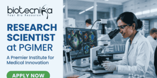 Research Scientist Vacancy at PGIMER Earn Upto ₹56,000. A featured image for a job page with a clean, professional layout. On the left side, against a light blue and white background, the Biotecnika logo is at the top, followed by the bold blue text "RESEARCH SCIENTIST at PGIMER" and a tagline "A Premier Institute for Medical Innovation." At the bottom left is a green "APPLY NOW" button. The right side of the image features a realistic, high-quality photo of a female scientist in a white lab coat and safety glasses working with a pipette in a modern laboratory. In the background, large computer monitors display vibrant, detailed microscopic imaging of cell structures.