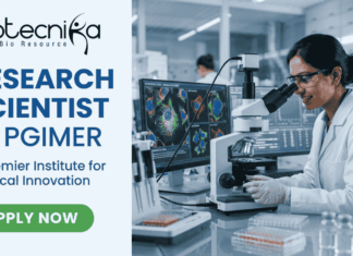 Research Scientist Vacancy at PGIMER | Cancer Research Role with ₹56,000 Salary! Research Scientist Vacancy at PGIMER Earn Upto ₹56,000. A featured image for a job page with a clean, professional layout. On the left side, against a light blue and white background, the Biotecnika logo is at the top, followed by the bold blue text "RESEARCH SCIENTIST at PGIMER" and a tagline "A Premier Institute for Medical Innovation." At the bottom left is a green "APPLY NOW" button. The right side of the image features a realistic, high-quality photo of a female scientist in a white lab coat and safety glasses working with a pipette in a modern laboratory. In the background, large computer monitors display vibrant, detailed microscopic imaging of cell structures.