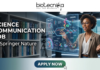 Science Communication Job at Springer Nature Don't Miss It. A professional featured image for a "Science Communication Job at Springer Nature." The layout features the Biotecnika logo at the top and a prominent "Apply Now" button at the bottom. To the right, a professional woman in a modern setting interacts with a glowing, futuristic DNA and CRISPR hologram, symbolizing science communication. Large, bold text on the left reads "SCIENCE COMMUNICATION JOB at Springer Nature.