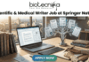 Scientific & Medical Writer Job at Springer Nature Pune. A professional featured image for a job post titled "Scientific & Medical Writer Job at Springer Nature." The image depicts a woman working on a laptop at a wooden desk in a bright office. To her left is a stack of scientific books like "Methods in Molecular Biology," and to her right is a unique digital tree graphic displaying icons for "Bio Science Review" and "Clinical Data Studies." A historic university campus is visible through the window in the background. The Biotecnika logo is positioned at the top, and a blue "Apply Now" button is at the bottom center.