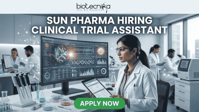 Sun Pharma Hiring Clinical Trial Assistant Apply Now (1) Sun Pharma Hiring Clinical Trial Assistant Apply Now. A professional and high-tech promotional image for a job opening. At the top, the Biotecnika logo is placed above the bold, capitalized headline: "SUN PHARMA HIRING CLINICAL TRIAL ASSISTANT". The central focus is a female scientist in a white lab coat and safety glasses, intently working at a desk. She is looking at a large, curved digital monitor that displays intricate clinical trial data, 3D molecular structures, and a glowing sun-like graphic representing the company theme. The laboratory setting is bright and modern, with other researchers working in the background and scientific equipment like pipettes and vials visible on the desk. At the bottom center, a vibrant green "APPLY NOW" button stands out, making the image an effective, scroll-stopping recruitment graphic.
