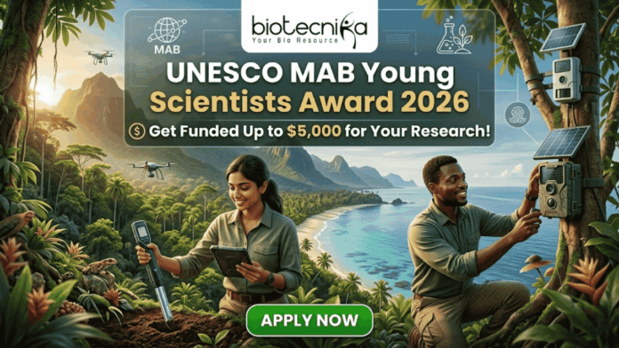 UNESCO MAB Young Scientists Award 2026 – Get Funded Up to $5,000 for Your Research! UNESCO MAB Young Scientists Award 2026 – Get Funded Up to $5,000 for Your Research! A featured job post image for the UNESCO MAB Young Scientists Award 2026. At the top center is the Biotecnika logo. The main text reads "UNESCO MAB Young Scientists Award 2026" with a sub-headline, "Get Funded Up to $5,000 for Your Research!" The background features a realistic and vibrant tropical coastal landscape with lush green mountains and turquoise water. Two scientists—a woman and a man in khaki field gear—are shown conducting environmental research; the woman uses a handheld probe and tablet while the man inspects a sensor device mounted on a tree. Drones fly in the background, emphasizing a high-tech conservation theme. At the bottom center is a prominent green "APPLY NOW" button.