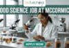 Urgent Food Science Job at McCormick – QA Executive Hiring in Sonipat! A high-quality promotional featured image for a "Food Science Job at McCormick." The graphic features a female scientist of Indian ethnicity in a professional white lab coat and safety goggles, meticulously using a pipette to test a sample in a petri dish. The laboratory setting is bright and modern, with the foreground showcasing several glass jars filled with vibrant, colorful spices like turmeric, paprika, and dried herbs, reflecting the McCormick brand's focus. The top of the image displays the Biotecnika logo, while a large, bold heading reads "FOOD SCIENCE JOB AT MCCORMICK" across the top. At the bottom center, there is a prominent, rounded teal "APPLY NOW" button.