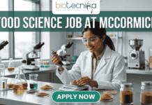Urgent Food Science Job at McCormick – QA Executive Hiring in Sonipat! Urgent Food Science Job at McCormick – QA Executive Hiring in Sonipat! A high-quality promotional featured image for a "Food Science Job at McCormick." The graphic features a female scientist of Indian ethnicity in a professional white lab coat and safety goggles, meticulously using a pipette to test a sample in a petri dish. The laboratory setting is bright and modern, with the foreground showcasing several glass jars filled with vibrant, colorful spices like turmeric, paprika, and dried herbs, reflecting the McCormick brand's focus. The top of the image displays the Biotecnika logo, while a large, bold heading reads "FOOD SCIENCE JOB AT MCCORMICK" across the top. At the bottom center, there is a prominent, rounded teal "APPLY NOW" button.
