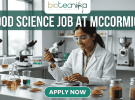 Urgent Food Science Job at McCormick – QA Executive Hiring in Sonipat! Urgent Food Science Job at McCormick – QA Executive Hiring in Sonipat! A high-quality promotional featured image for a "Food Science Job at McCormick." The graphic features a female scientist of Indian ethnicity in a professional white lab coat and safety goggles, meticulously using a pipette to test a sample in a petri dish. The laboratory setting is bright and modern, with the foreground showcasing several glass jars filled with vibrant, colorful spices like turmeric, paprika, and dried herbs, reflecting the McCormick brand's focus. The top of the image displays the Biotecnika logo, while a large, bold heading reads "FOOD SCIENCE JOB AT MCCORMICK" across the top. At the bottom center, there is a prominent, rounded teal "APPLY NOW" button.