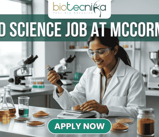 Urgent Food Science Job at McCormick – QA Executive Hiring in Sonipat! A high-quality promotional featured image for a "Food Science Job at McCormick." The graphic features a female scientist of Indian ethnicity in a professional white lab coat and safety goggles, meticulously using a pipette to test a sample in a petri dish. The laboratory setting is bright and modern, with the foreground showcasing several glass jars filled with vibrant, colorful spices like turmeric, paprika, and dried herbs, reflecting the McCormick brand's focus. The top of the image displays the Biotecnika logo, while a large, bold heading reads "FOOD SCIENCE JOB AT MCCORMICK" across the top. At the bottom center, there is a prominent, rounded teal "APPLY NOW" button.