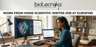 Work From Home Scientific Writer Job at Eurofins | Life Science Graduates Don’t Miss This! Work From Home Scientific Writer Job at Eurofins. A high-quality, realistic featured image for a "Work From Home Scientific Writer Job at Eurofins." The scene depicts a professional woman in a bright, modern home office, focused on her dual-monitor setup. One screen shows a detailed 3D protein structure, while the other displays a scientific manuscript. Her desk is neatly organized with a laptop, a mechanical keyboard, a "scientific" coffee mug, and molecular models. A cozy home atmosphere is suggested by a cat sitting on the windowsill in the background. The Biotecnika logo is featured at the top center, the job title is in bold black text, and a teal "APPLY NOW" button is centered at the bottom.