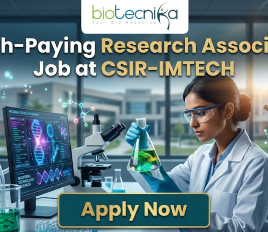 Research Associate Job at CSIR-IMTECH | Apply Now. A high-quality promotional image for a "High-Paying Research Associate Job at CSIR-IMTECH" featuring the Biotecnika Global logo at the top center. The scene depicts a female scientist in a professional lab coat and safety goggles, carefully holding a flask filled with a glowing, bioluminescent green liquid. In the background, a modern laboratory is visible with a computer monitor displaying advanced microbial technology research, DNA structures, and molecular data. The lighting is a sleek, futuristic blue, and a prominent "Apply Now" button is positioned at the bottom center.