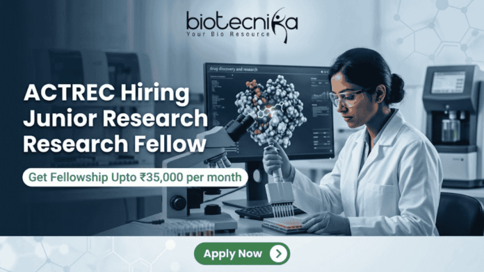 ACTREC Hiring Junior Research Fellow Opportunity in Cancer Research ACTREC Hiring Junior Research Fellow Opportunity in Cancer Research. An advertisement for a Junior Research Fellow position at ACTREC, showing the Biotecnika logo at the top center. Text states: 'ACTREC Hiring Junior Research Fellow' and 'Get Fellowship Upto ₹35,000 per month'. A photograph on the right shows a female scientist in a lab coat, safety glasses, and blue gloves operating a multichannel pipette. Behind her, a monitor displays molecular drug discovery data. Various advanced lab instruments are in the background. At the bottom, a green 'Apply Now' button.