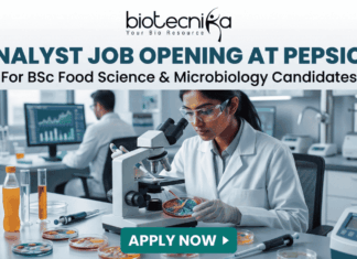 Analyst Job Opening at PepsiCo for BSc Food Science & Microbiology Candidates Analyst Job at PepsiCo BSc Food Science & Microbiology. A promotional banner from Biotecnika advertising an "ANALYST JOB OPENING AT PEPSICO for BSc Food Science & Microbiology Candidates". The visual features a female researcher in a lab coat and safety glasses using a compound microscope to examine colorful samples in a Petri dish. Laboratory equipment, test bottles with various food product liquids, and a male colleague working at a computer station are in the background. The Biotecnika logo is at the top, and a teal "APPLY NOW" button is at the bottom.