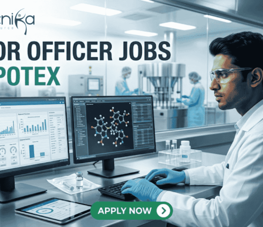 Apotex Hiring Junior Officers in Bangalore Apply Now! A professional recruitment banner for "JUNIOR OFFICER JOBS AT APOTEX" featuring the Biotecnika logo at the top left. The image depicts a young male pharmaceutical professional in a white lab coat and blue gloves, meticulously monitoring data on dual computer screens. One screen displays analytical charts and graphs, while the other shows a 3D molecular structure. In the background, a sterile pharmaceutical production line with stainless steel machinery is visible through a large glass partition. On the right side, vertical teal icons highlight key roles: "QC QA," "Data Analysis," "Sterile Production," "Sterile vial," and "Ladder chart." A prominent green "APPLY NOW" button with a white arrow is centered at the bottom.