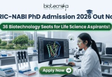 BRIC-NABI PhD Admission 2026 Out Now – 36 Biotechnology Seats for Life Science Aspirants! BRIC-NABI PhD Admission 2026 Out Now – 36 Biotechnology Seats for Life Science Aspirants!. A high-resolution corporate featured image for BRIC-NABI PhD Admission 2026. The top center features the Biotecnika logo above the bold text: "BRIC-NABI PhD Admission 2026 Out Now." Below this, a glowing green banner highlights "36 Biotechnology Seats for Life Science Aspirants!" The background shows a modern, bright laboratory setting where a female scientist is focused on a large curved monitor displaying a colorful 3D protein molecular structure. Lab equipment, including pipettes and a microscope, is visible on the clean white workstation. At the bottom center, there is a prominent green "Apply Now" button with a right-arrow icon.