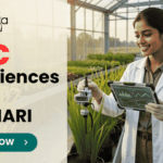 BSc Life Sciences Job Opportunity at ICAR-IARI Work on DBT Funded Project. A promotional image banner from biotecnika for a "BSc Life Sciences Job at ICAR-IARI". It features a photograph of a smiling female researcher in a white lab coat, holding a data tablet and adjusting a scientific sensor on a growing plant in a modern, sunlit greenhouse. A centrifuge and test tubes on a cart are to her side. The biotecnika logo is at the top left, and a green "APPLY NOW" button with an arrow is at the bottom center.
