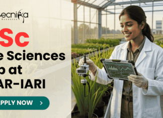 BSc Life Sciences Job Opportunity at ICAR-IARI | Work on DBT Funded Project BSc Life Sciences Job Opportunity at ICAR-IARI Work on DBT Funded Project. A promotional image banner from biotecnika for a "BSc Life Sciences Job at ICAR-IARI". It features a photograph of a smiling female researcher in a white lab coat, holding a data tablet and adjusting a scientific sensor on a growing plant in a modern, sunlit greenhouse. A centrifuge and test tubes on a cart are to her side. The biotecnika logo is at the top left, and a green "APPLY NOW" button with an arrow is at the bottom center.