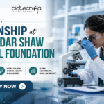 Research Internship at Mazumdar Shaw Medical Foundation. Research Internship at Mazumdar Shaw Medical Foundation banner featuring a scientist using a microscope in a modern lab, Biotecnika logo at the top, and an ‘Apply Now’ button highlighting hands-on research opportunities.
