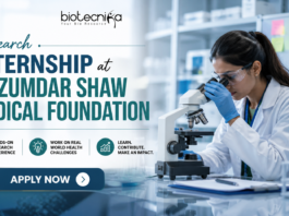 Research Internship at Mazumdar Shaw Medical Foundation. Research Internship at Mazumdar Shaw Medical Foundation banner featuring a scientist using a microscope in a modern lab, Biotecnika logo at the top, and an ‘Apply Now’ button highlighting hands-on research opportunities.