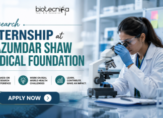 Research Internship at Mazumdar Shaw Medical Foundation. Research Internship at Mazumdar Shaw Medical Foundation banner featuring a scientist using a microscope in a modern lab, Biotecnika logo at the top, and an ‘Apply Now’ button highlighting hands-on research opportunities.