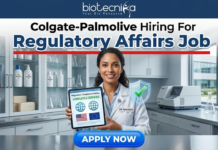 Colgate-Palmolive Hiring For Regulatory Affairs Job | BSc Life Science Job Colgate-Palmolive Hiring For Regulatory Affairs Job BSc Life Science Job. An image advertising a Regulatory Affairs job opening at Colgate-Palmolive, presented by Biotecnika. A smiling female regulatory specialist in a lab coat holds a tablet displaying a certified compliance status with US and EU flags and a green checkmark. A blue 'APPLY NOW' button is at the bottom.