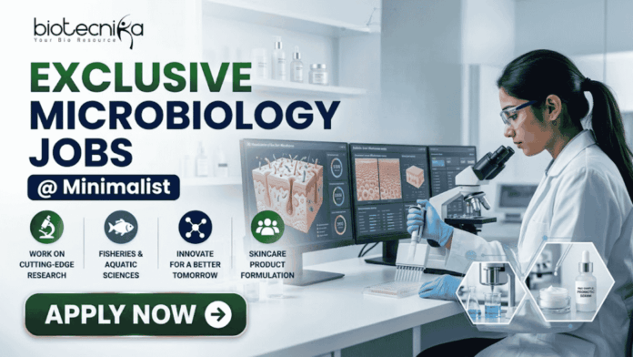 Exclusive Microbiology Jobs at Minimalist Apply For Quality Assurance Executive Role Exclusive Microbiology Jobs at Minimalist Apply For Quality Assurance Executive Role. A professional corporate recruitment banner for "EXCLUSIVE MICROBIOLOGY JOBS @ Minimalist" featuring the Biotecnika logo. The image showcases a focused female scientist in a white lab coat and blue gloves working in a high-tech laboratory. The theme is centered on skincare science, with laboratory monitors displaying "Skin Microbiome Analysis" and "Probiotic Effectiveness." Shelves in the background hold various skincare bottles and jars. Hexagonal graphics highlight scientific visualizations of skin cells and probiotic serums. Four circular icons at the bottom represent research, aquatic sciences, innovation, and skincare product formulation. A prominent green "APPLY NOW" button is positioned at the bottom left.