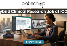 Hybrid Clinical Research Job at ICON | Life Science Graduates Must Apply! Hybrid Clinical Research Job at ICON | Life Science Graduates Must Apply! A job advertisement banner from Biotecnika for a Clinical Research position at ICON. The top center features the "biotecnika" logo with the tagline "Your Bio Resource". Below the logo, a prominent dark grey bar contains the large, bold white text headline: "Hybrid Clinical Research Job at ICON". The main visual is a detailed, realistic illustrative scene of a professional woman in a blazer and headphones seated at a desk with an office cityscape in the background. She is looking at three computer monitors: one showing a "Global Trial Management" data dashboard, another showing a live video conference with a team (labeled "Team Check-in - Remote Site"), and the third is a laptop. Objects on the desk include a coffee mug that reads "COFFEE & CLINICAL DATA", a stack of "Good Clinical Practice Guide" books, and vials. At the bottom center, a pulsing teal-colored rounded rectangular button with white text reads "APPLY NOW".