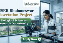 NISER Bhubaneswar Dissertation Project | Biological Sciences Research Opportunity! Corporate-style recruitment banner for NISER Bhubaneswar Dissertation Project. The image features a female scientist in a lab coat interacting with a protein structure on a monitor. Text includes "Biological Sciences Research Opportunity!" and the Biotecnika logo, with a green "Apply Now" button at the bottom.