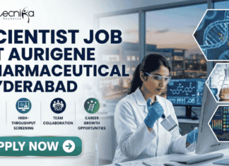 Scientist Job in Hyderabad for MSc Graduates | Aurigene Pharmaceutical Hiring Now Scientist Job for MSc Graduates at Aurigene Pharmaceutical. A professional corporate recruitment banner for a "SCIENTIST JOB AT AURIGENE PHARMACEUTICAL HYDERABAD" by Biotecnika. The image features a focused female scientist of Indian heritage in a lab coat and safety glasses, working with a multichannel pipette in a state-of-the-art pharmaceutical laboratory. The background shows a modern research facility with large windows overlooking a city skyline at dusk. Hexagonal frames to the right showcase a DNA helix, chemical glassware, and data analytics. Below the main headline, four icons highlight key aspects: Advanced Drug R&D, High-Throughput Screening, Team Collaboration, and Career Growth Opportunities. A prominent teal "APPLY NOW" button is positioned at the bottom left.