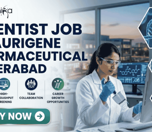 Scientist Job in Hyderabad for MSc Graduates | Aurigene Pharmaceutical Hiring Now Scientist Job for MSc Graduates at Aurigene Pharmaceutical. A professional corporate recruitment banner for a "SCIENTIST JOB AT AURIGENE PHARMACEUTICAL HYDERABAD" by Biotecnika. The image features a focused female scientist of Indian heritage in a lab coat and safety glasses, working with a multichannel pipette in a state-of-the-art pharmaceutical laboratory. The background shows a modern research facility with large windows overlooking a city skyline at dusk. Hexagonal frames to the right showcase a DNA helix, chemical glassware, and data analytics. Below the main headline, four icons highlight key aspects: Advanced Drug R&D, High-Throughput Screening, Team Collaboration, and Career Growth Opportunities. A prominent teal "APPLY NOW" button is positioned at the bottom left.