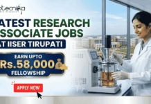 Latest Research Associate Jobs at IISER Tirupati | Earn Upto Rs.58,000 Fellowship Latest Research Associate Jobs at IISER Tirupati | Earn Upto Rs.58,000 Fellowship. A professional recruitment banner for "Latest Research Associate Jobs at IISER Tirupati," featuring the Biotecnika logo at the top left. On the right, a female scientist in a white lab coat and gloves is shown working with a laboratory bioreactor in a bright, modern lab setting. The background through a large window offers a realistic view of the IISER Tirupati campus. The left side of the image features the bold headline "LATEST RESEARCH ASSOCIATE JOBS AT IISER TIRUPATI." Below this, a prominent gold-framed blue box highlights the fellowship: "EARN UPTO Rs. 58,000 FELLOWSHIP" accompanied by an icon of a money bag. Three circular icons highlight key benefits: Conduct Advanced Bio-Research, Collaboration & Mentorship, and Career Growth Path. A large green "Apply Now" button with a white arrow and the website "biotecnika.org" are positioned at the bottom.