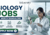 Biology Jobs at Merck in Bangalore | Apply Before It’s Gone Biology Jobs at Merck in Bangalore | Apply Before It's Gone. A Biotecnika recruitment banner advertising 'Biology Jobs' at 'Merck Bangalore.' On the right, a detailed photograph of a female scientist in a lab coat, safety glasses, and gloves meticulousy pipetting into a multi-well plate in a modern laboratory. The window behind her reveals a modern cityscape (Bangalore). The main text 'BIOLOGY JOBS' is stacked in large green and blue fonts, with 'AT MERCK BANGALORE' in a blue bar below it. Below the text, three circular icons with descriptive text list focus areas: 'ADVANCED DRUG DISCOVERY,' 'CELL LINE DEVELOPMENT,' and 'GENOMICS & PROTEOMICS.' The Biotecnika logo is in the top corner, and a prominent green 'APPLY NOW' button with a right arrow is at the bottom-left.