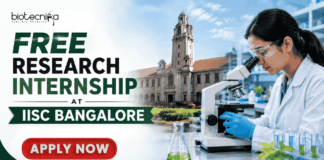 Free Research Internship at IISC Bangalore Golden Opportunity You Can't Miss!! Featured banner for “Free Research Internship at IISC Bangalore” featuring the Biotecnika logo at the top, a researcher using a microscope in a modern laboratory, an academic campus backdrop, research and innovation-themed highlights, and a bold “Apply Now” button at the bottom.