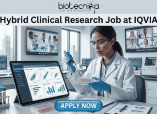 Hybrid Clinical Research Job at IQVIA | Opening for Life Science Graduates! Hybrid Clinical Research Job at IQVIA Opening for Life Science Graduates! A promotional graphic titled "Hybrid Clinical Research Job at IQVIA" at the top center, just below the biotecnika logo. The central image is a female researcher in a lab coat, nitrile gloves, and safety glasses, focused on carefully using a pipette on a multi-well plate. To her left is a large tablet displaying various clinical research charts and data plots. To her right is a paper titled "Remote Connection" and a coffee cup with a sleeve that reads "flex work". Large screens in the background show other scientists collaborating and a multi-person video conference call with a diverse team under the title "Global Team Collaboration". A centrifuge and other lab equipment are visible in the background. A prominent blue button at the bottom center reads "APPLY NOW".