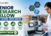 ICGEB New Delhi Hiring Senior Research Fellow | Work in Plant Molecular Biology Research ICGEB New Delhi Hiring Senior Research Fellow Work in Plant Molecular Biology Research. A professional recruitment banner for a "Senior Research Fellow at ICGEB, New Delhi," featuring the Biotecnika logo at the top left. On the right side, a female scientist in a white lab coat operates advanced automated laboratory equipment, with floating hexagonal graphics of protein structures and a DNA helix above her. The background displays a realistic, sunlit view of a modern research institute campus. The left side features the bold headline and four circular icons representing key roles: Lead Advanced Research Projects, Publish High-Impact Findings, Mentor Junior Scholars, and State-of-the-Art Lab Access. A prominent green "Apply Now" button with a white arrow is located at the bottom left.