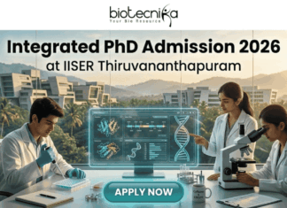 Integrated PhD Admission 2026 at IISER Thiruvananthapuram. An inspiring featured image for Integrated PhD admission, featuring three students in lab coats collaborating in a modern IISER Thiruvananthapuram laboratory during golden hour. Large text at the top reads: "Integrated PhD Admission 2026 at IISER Thiruvananthapuram", with the Biotecnika logo. Below, students are pointing at a transparent screen with DNA structures and using a microscope, with a witty "Caffeine & CRISPR" mug. A large teal "APPLY NOW" button is at the bottom center.